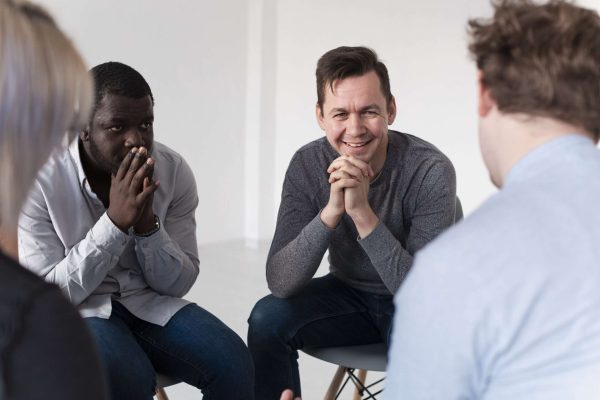 smiling-male-patient-talking-with-his-friends