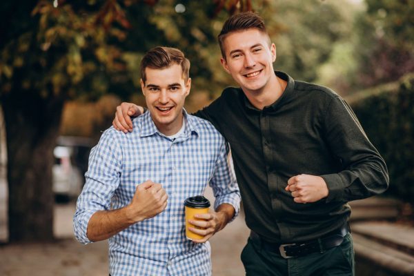 Young adults guys walking together inpark